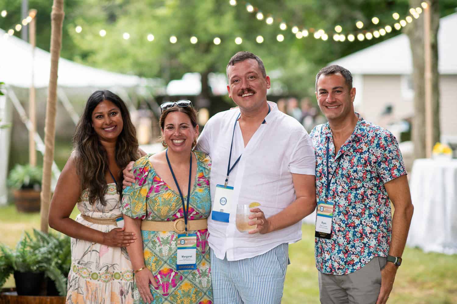 Colleagues smiling together during an outdoor networking event